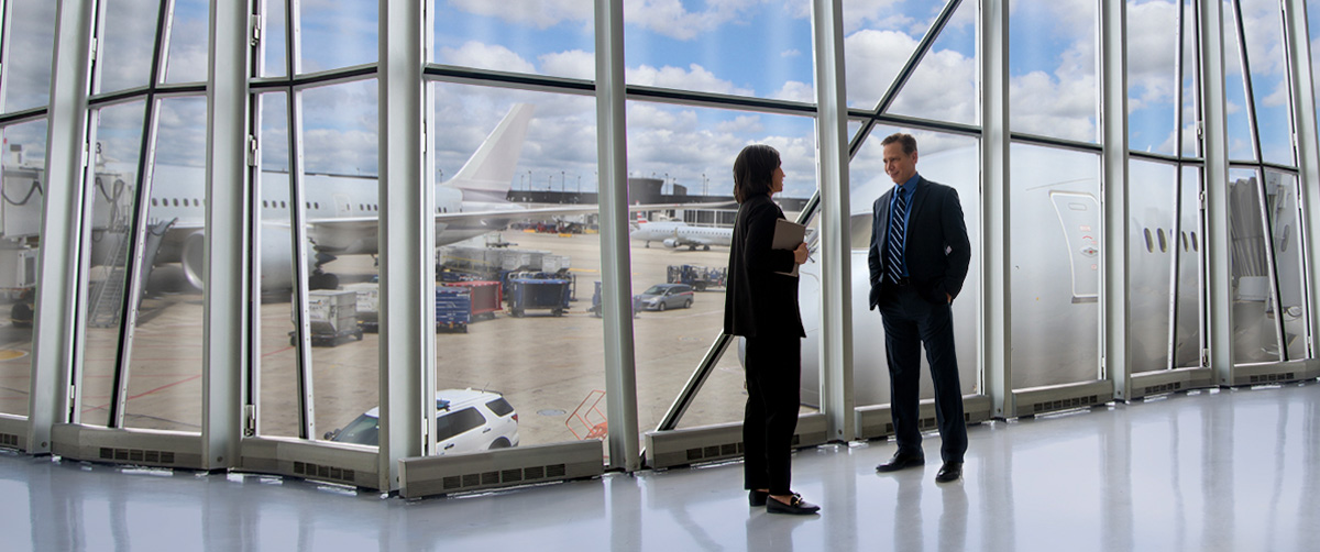 two people talking in an airport terminal